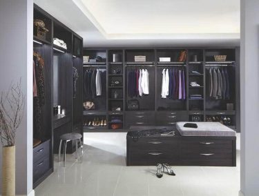 Dressing room with fitted wardrobes and central island in Aura Black