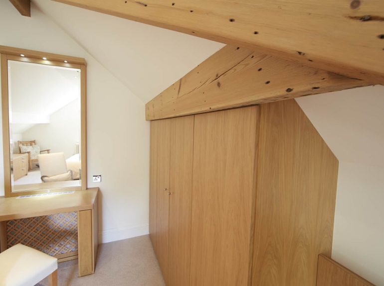 Strachan wardrobes fitted against slanting ceiling