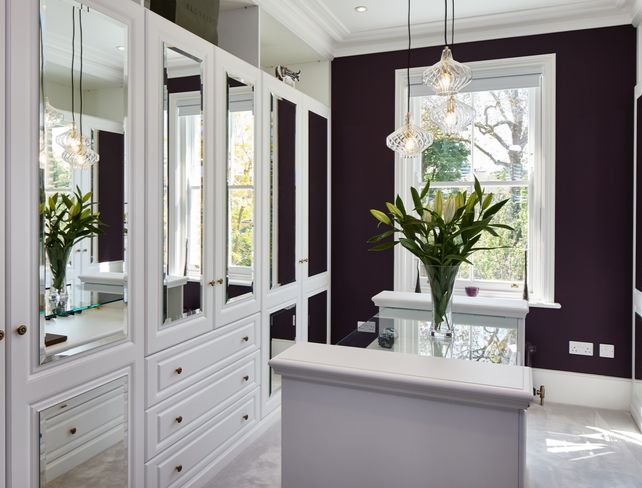 A traditional dove white dressing room with luxurious detail & mirrored wardrobe doors