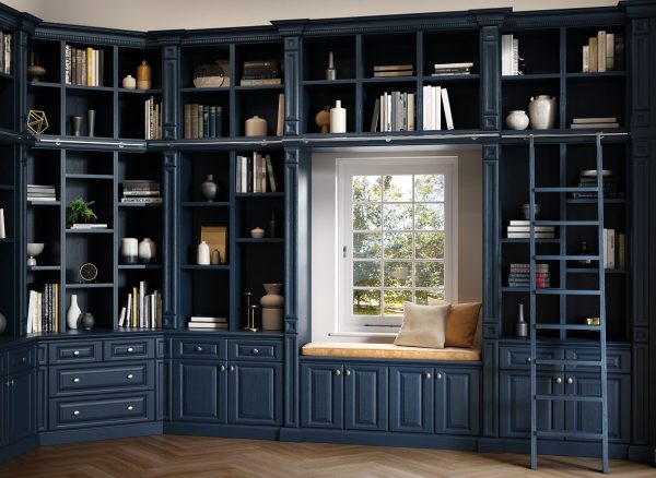 Blue fitted library bookshelves and window seat