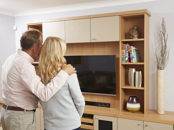 Couple admiring their new fitted furniture Couple admiring their new fitted furniture