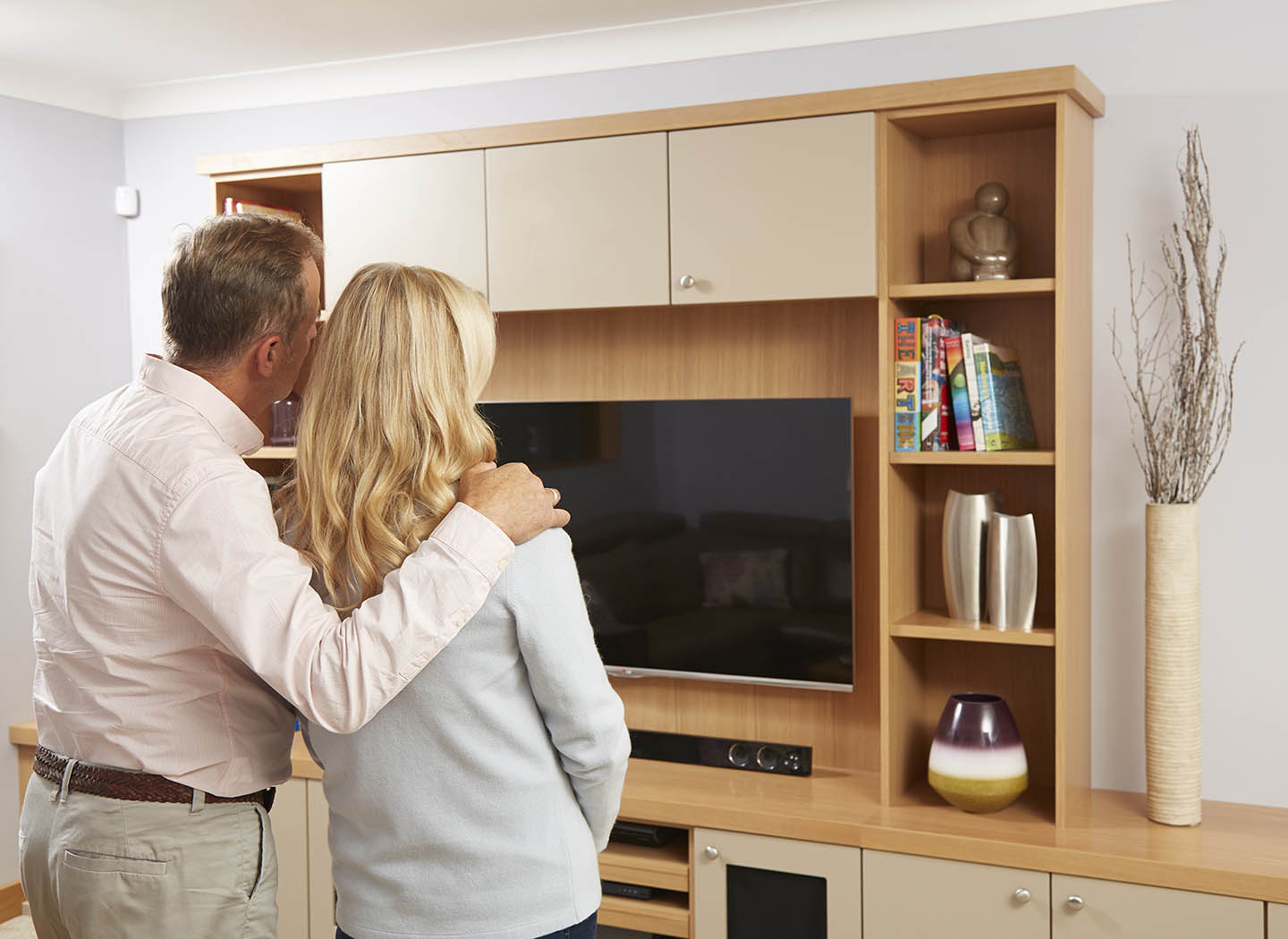 Couple admiring their new fitted furniture