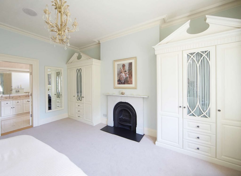 Alcove wardrobes fitted either side of chimney breast