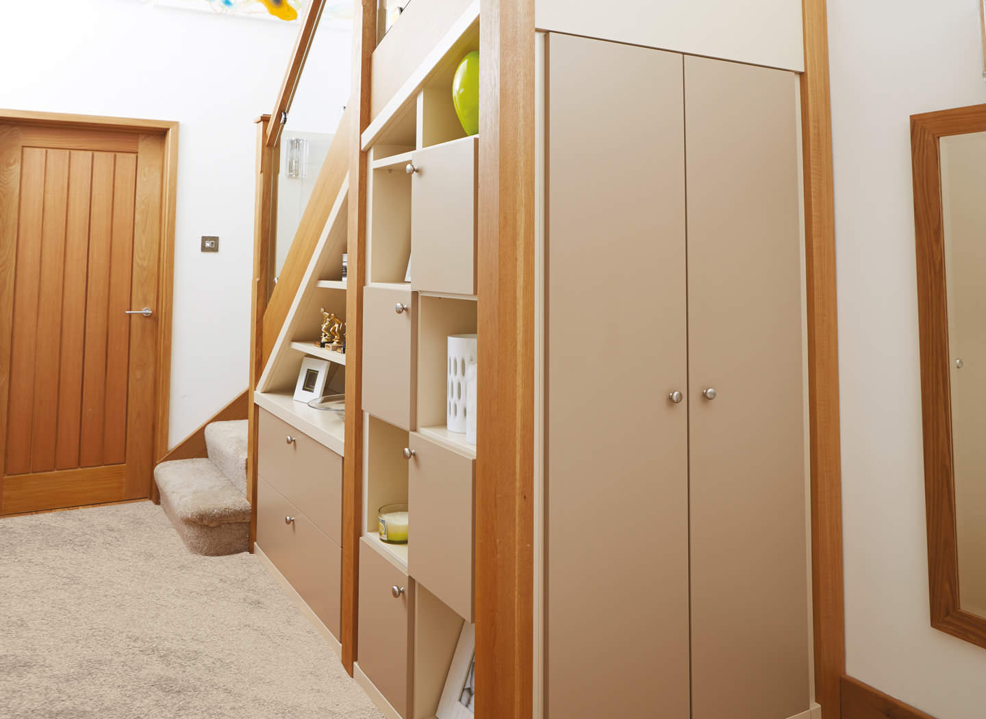 A cupboard under the stairs with drawers and cupboards for hiding valuables