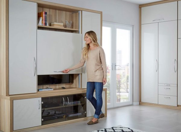 Woman sliding the pull up tv panel