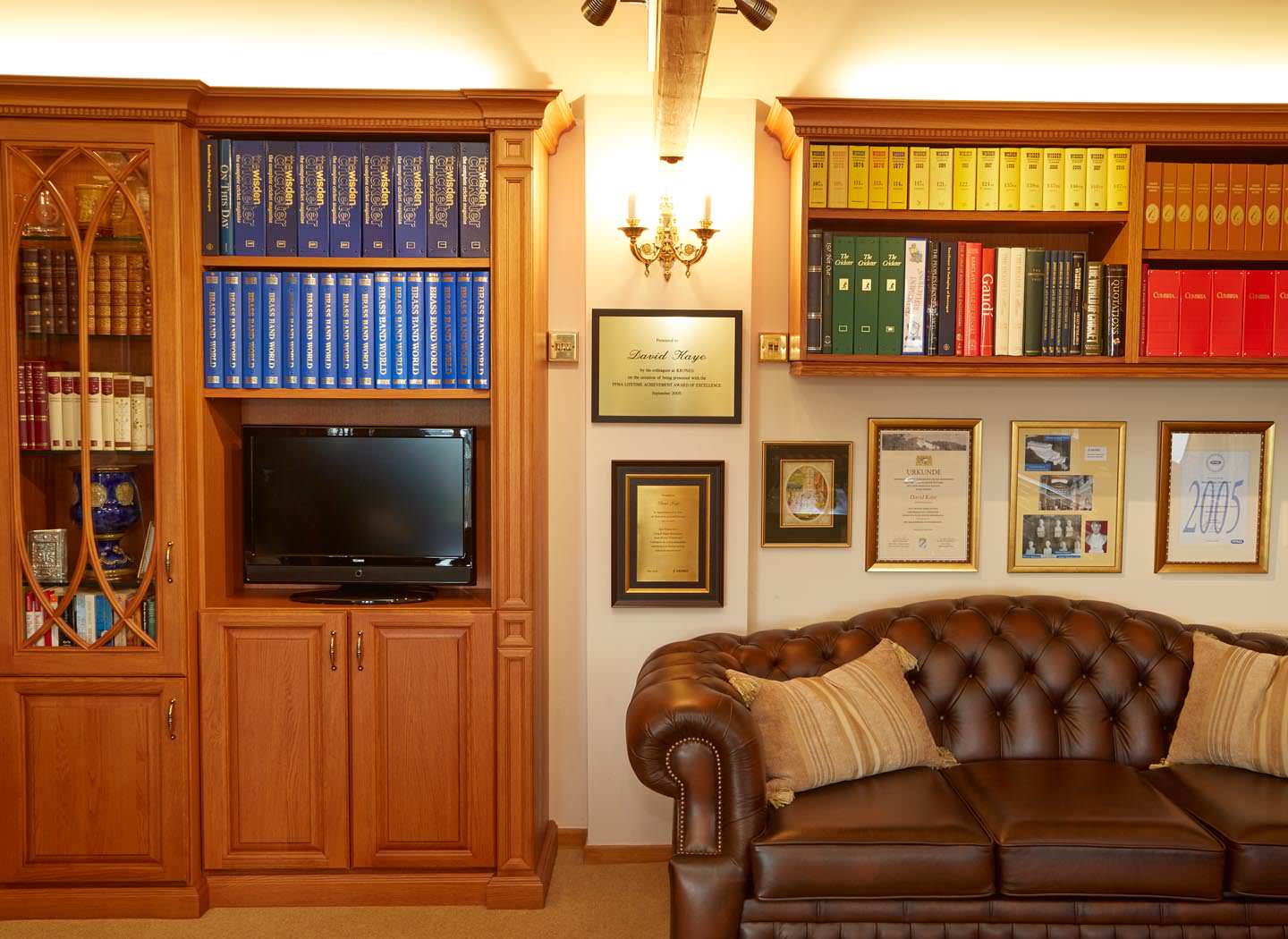 Glass fronted cabinet and overhead bookshelves