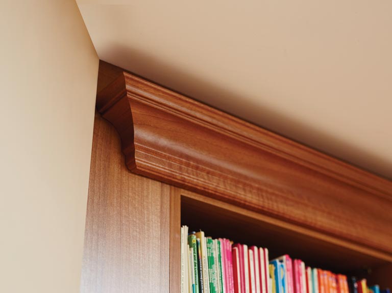 Tapered cornicing adjacent to fireplace