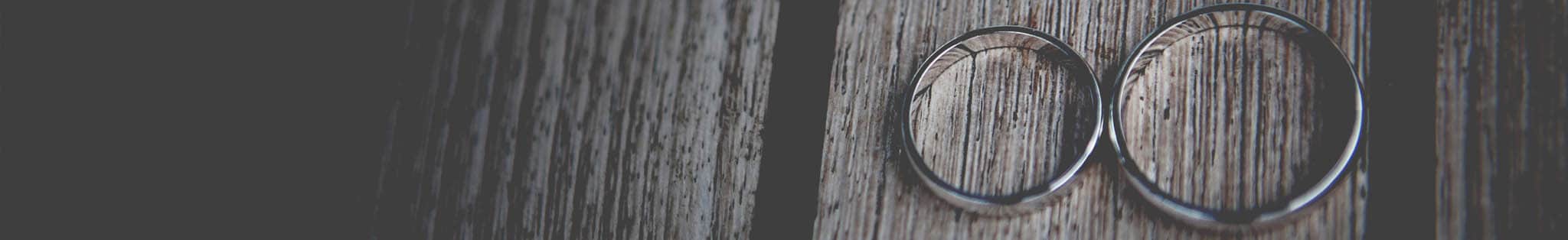 Silver rings on dark wood