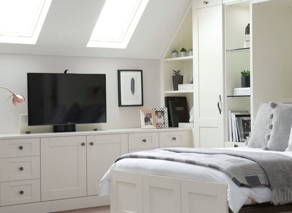 Fitted bedroom furniture with pop-up television storage solution