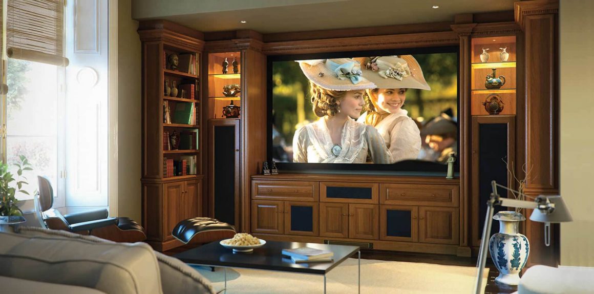 Fitted home cinema in Shades of in a mellow oak finish