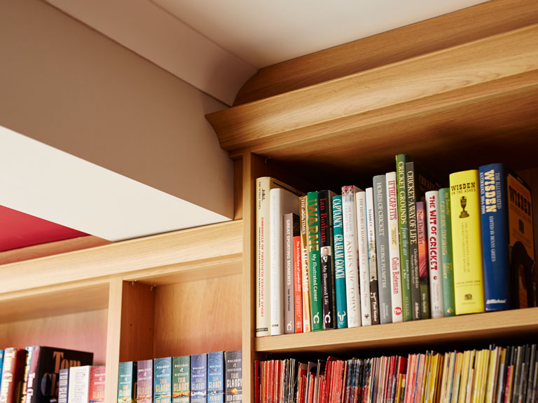 Dual height fitted bookcases with bespoke cornice detail