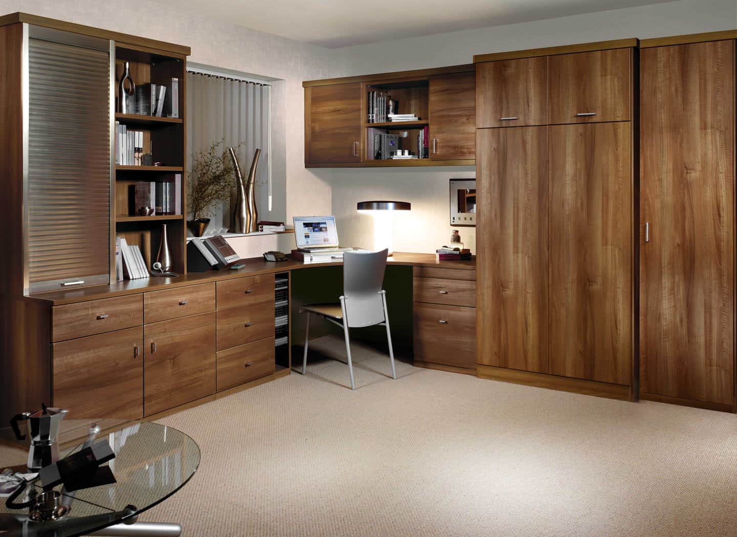 A walnut finished curved desk fitted to the corner of a room