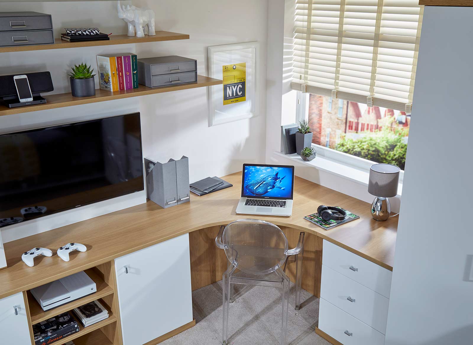 A computer desk fitted to the corner of a study bedroom