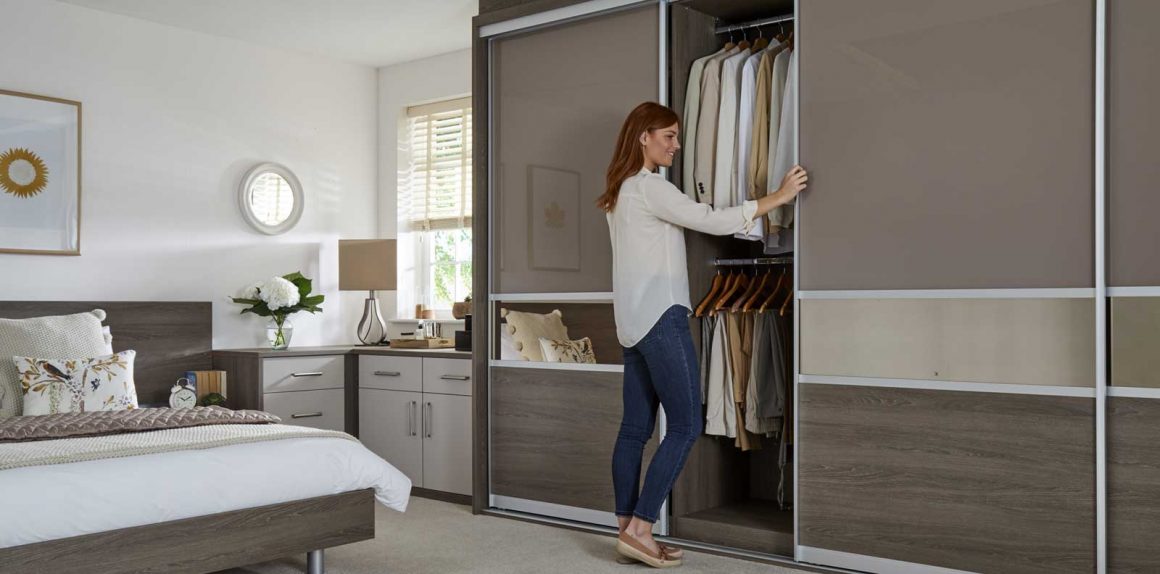 A woman hiding valuable items in her wardrobe