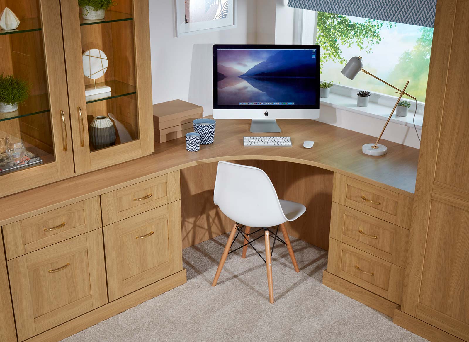 A perfectly fitted wooden corner desk in a home office