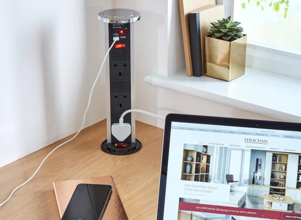 Power supply tower integrated within the Oak desk